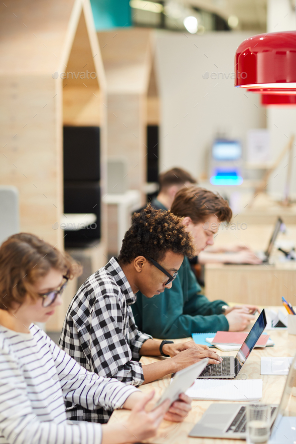 Students in line doing hometask in library - Stock Photo - Images