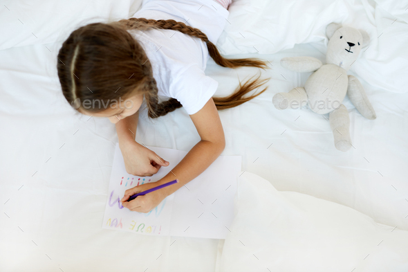 Girl Drawing in Bed - Stock Photo - Images