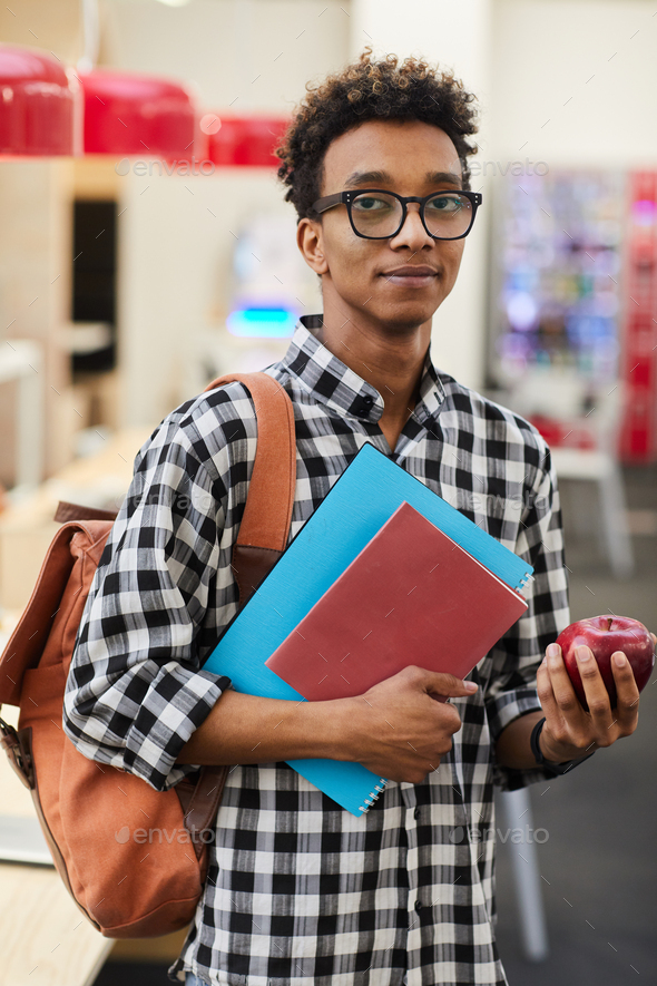 African-American student with apple - Stock Photo - Images