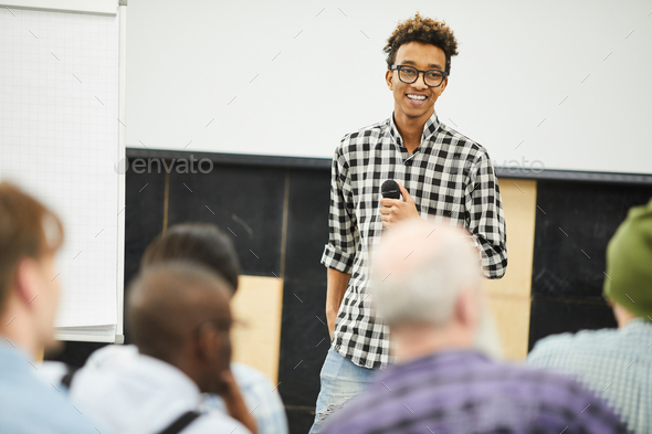 Positive successful young entrepreneur at business conference - Stock Photo - Images