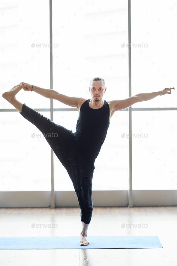 Yogis balancing on one leg - Stock Photo - Images