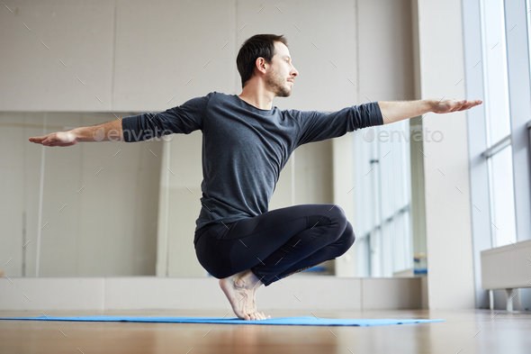 Man balancing on toes - Stock Photo - Images
