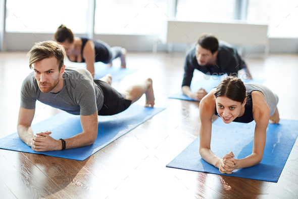 Motivated young people doing elbow plank - Stock Photo - Images