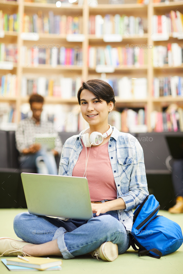 Student girl using online resource on laptop - Stock Photo - Images
