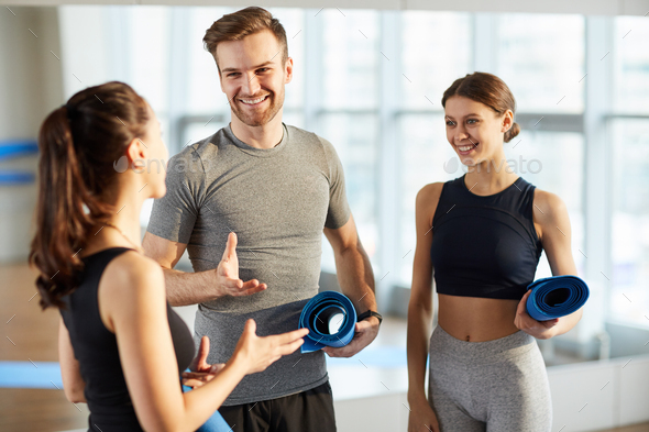 Yoga students sharing expressions about class - Stock Photo - Images