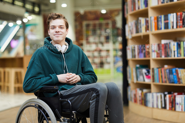 Content disabled student in library - Stock Photo - Images