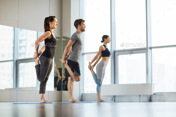 Stretching hips at yoga class - Stock Photo - Images