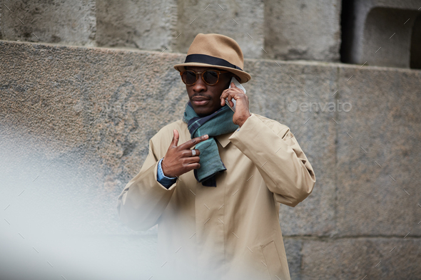 Modern African Man Speaking by Phone in City - Stock Photo - Images