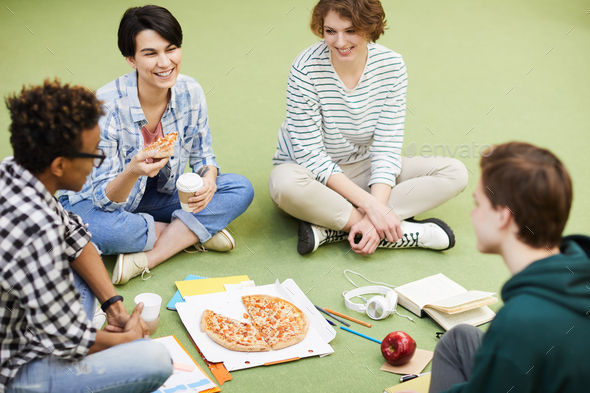 Students eating pizza - Stock Photo - Images