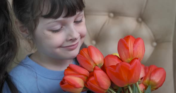 Happy child with tulips.  alt