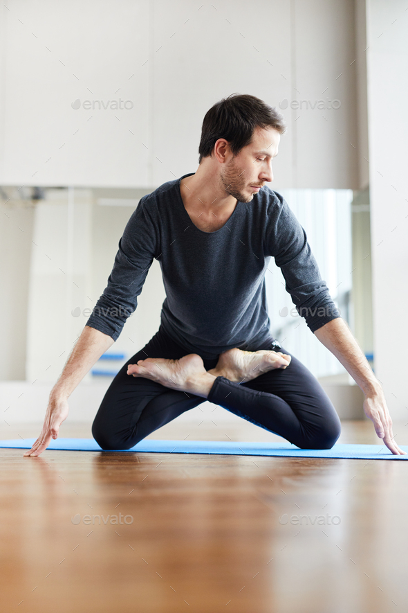 Young yogis standing on knees in lotus position - Stock Photo - Images