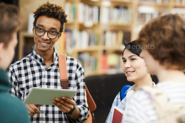 Student friends discussing research project - Stock Photo - Images