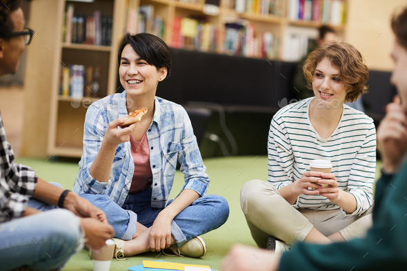 Excited friends eating pizza together - Stock Photo - Images