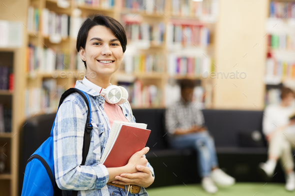 Confident university student in library - Stock Photo - Images