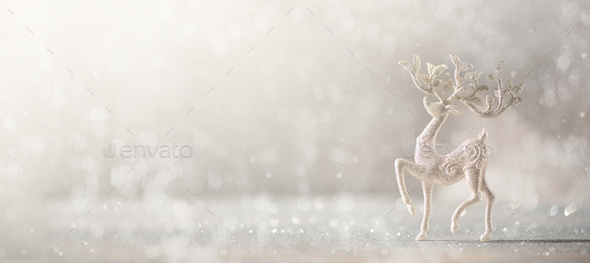 Silver glitter Christmas deer on grey background with lights bokeh, copy space. Greeting card for - Stock Photo - Images