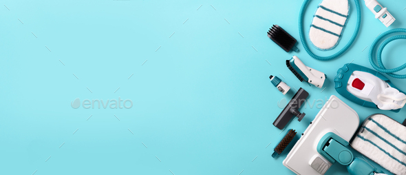 Set with modern professional steam cleaners on blue background. Top view, flat lay. Banner with copy - Stock Photo - Images