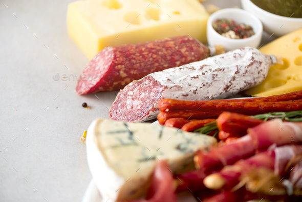 Traditional italian antipasto, cutting board with salami, cold smoked meat, prosciutto, ham, cheeses - Stock Photo - Images