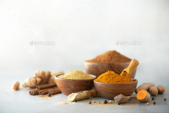 Ingredients for turmeric latte. Ground turmeric, curcuma root, cinnamon, ginger, black pepper on - Stock Photo - Images