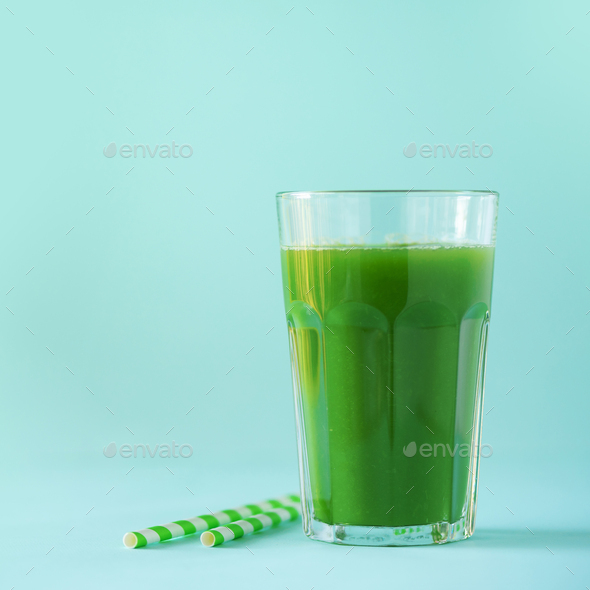 Glass of green celery smoothie on blue background. Banner with copy space. Fresh juice for detox - Stock Photo - Images