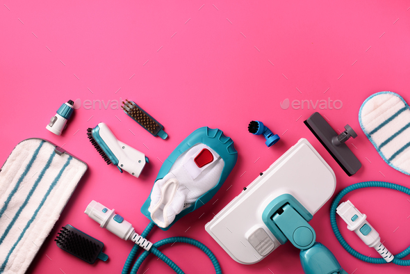 Set with modern professional steam cleaners on pink background. Top view, flat lay. Banner with copy - Stock Photo - Images