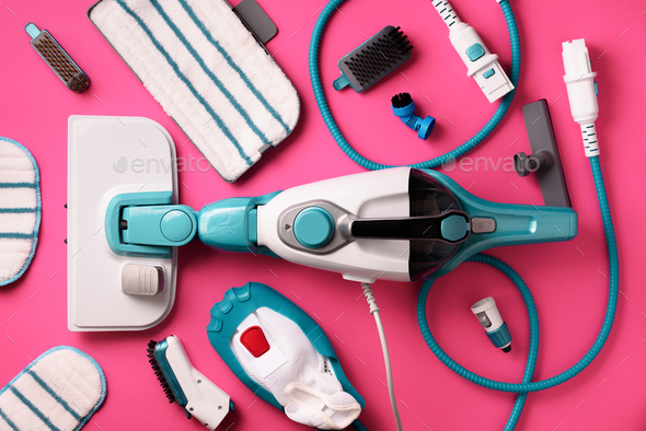 Kit of modern professional steam cleaners on pink background. Top view, flat lay. Banner with copy - Stock Photo - Images