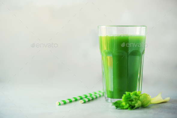 Glass of green celery smoothie on grey concrete background. Banner with copy space. Fresh juice for - Stock Photo - Images