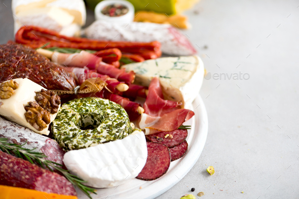 Cheese and meat appetizer. Traditional italian antipasto. Cutting board with salami, cold smoked - Stock Photo - Images
