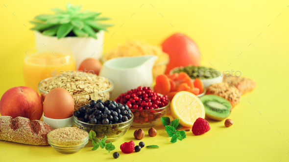 Organic food frame. Banner. Healthy breakfast ingredients. Oat and corn flakes, eggs, nuts, fruits - Stock Photo - Images