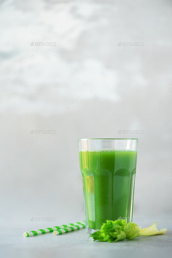 Glass of green celery smoothie on grey concrete background. Banner with copy space. Fresh juice for - Stock Photo - Images
