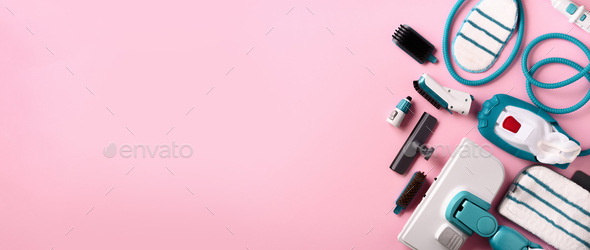 Kit of modern professional steam cleaners on pink background. Top view, flat lay. Banner with copy - Stock Photo - Images