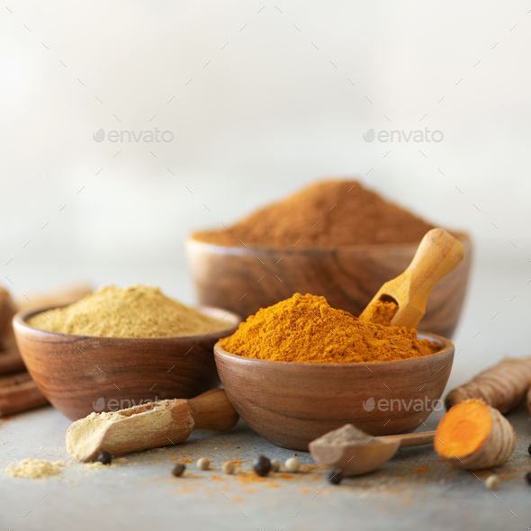 Ingredients for turmeric latte. Ground turmeric, curcuma root, cinnamon, ginger, black pepper on - Stock Photo - Images