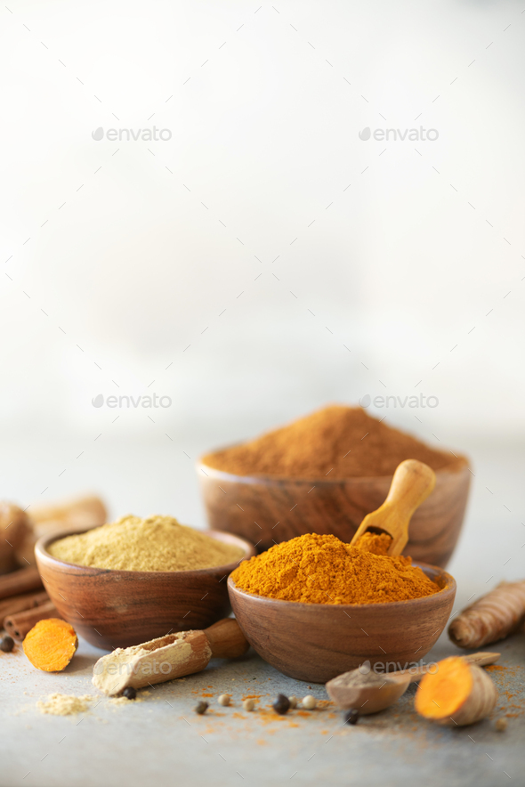 Ingredients for turmeric latte. Ground turmeric, curcuma root, cinnamon, ginger, black pepper on - Stock Photo - Images