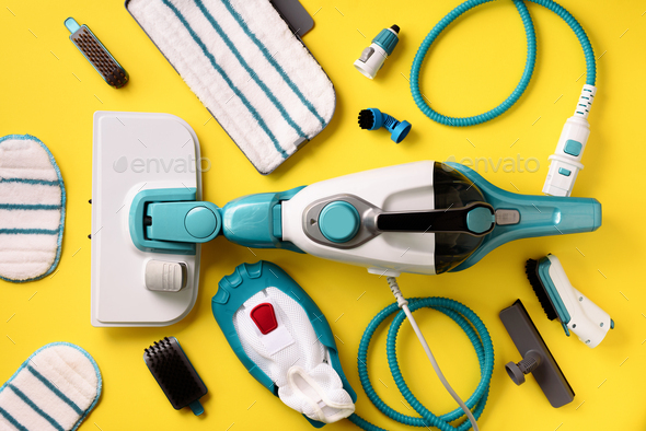 Kit of modern professional steam cleaners on yellow background. Top view, flat lay. Banner with copy - Stock Photo - Images