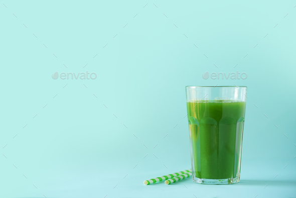 Glass of green celery smoothie on blue background. Banner with copy space. Fresh juice for detox - Stock Photo - Images
