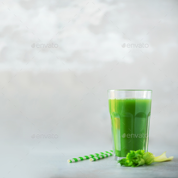Glass of green celery smoothie on grey concrete background. Banner with copy space. Square crop - Stock Photo - Images