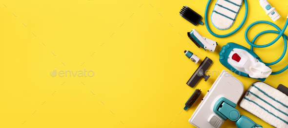 Set with modern professional steam cleaners on yellow background. Top view, flat lay. Banner with - Stock Photo - Images