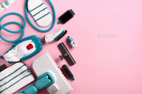 Set with modern professional steam cleaners on pink background. Top view, flat lay. Banner with copy - Stock Photo - Images