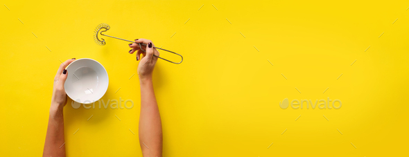 Female hands holding cooking equipment for meringue, sponge cake, biscuit baking. Whisk and white - Stock Photo - Images