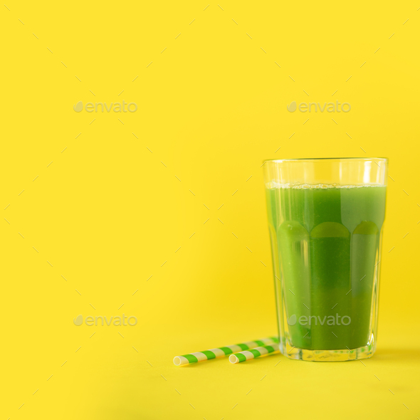Glass of green celery smoothie on yellow background. Banner with copy space. Square crop. Vegan - Stock Photo - Images