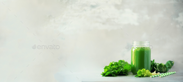 Bottle of green celery smoothie on grey concrete background. Banner with copy space. Square crop - Stock Photo - Images