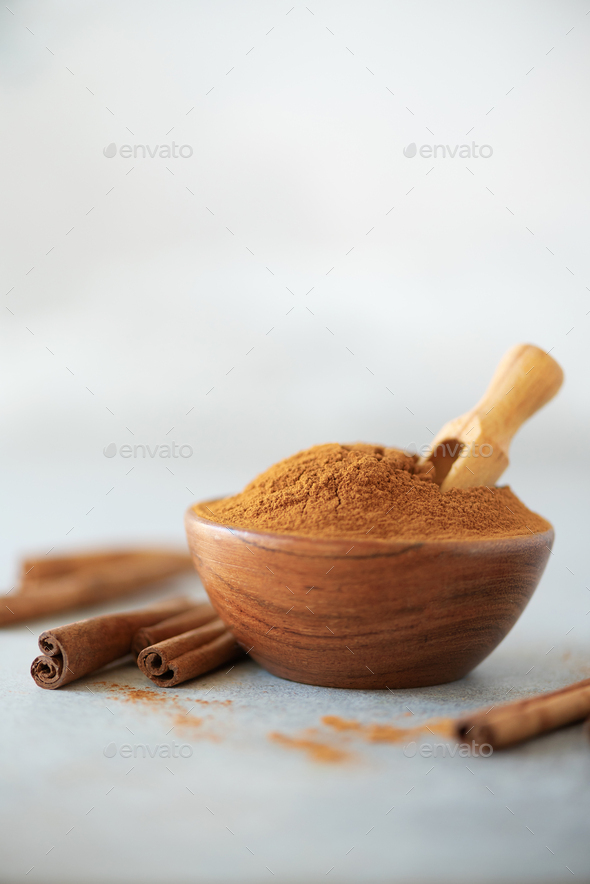 Cinnamon sticks and powder on grey background. Spices for ayurvedic  treatment. Alternative medicine Stock Photo by jchizhe