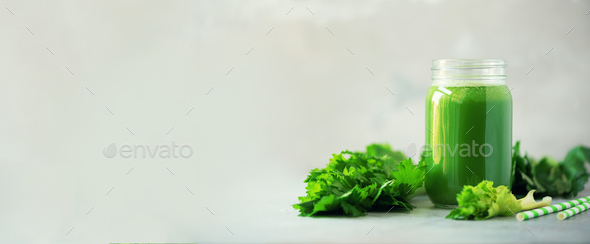 Bottle of green celery smoothie on grey concrete background. Banner with copy space. Square crop - Stock Photo - Images