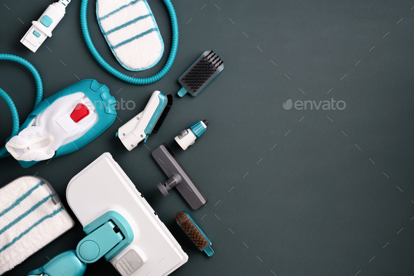 Kit of modern professional steam cleaners on grey background. Top view, flat lay. Banner with copy - Stock Photo - Images