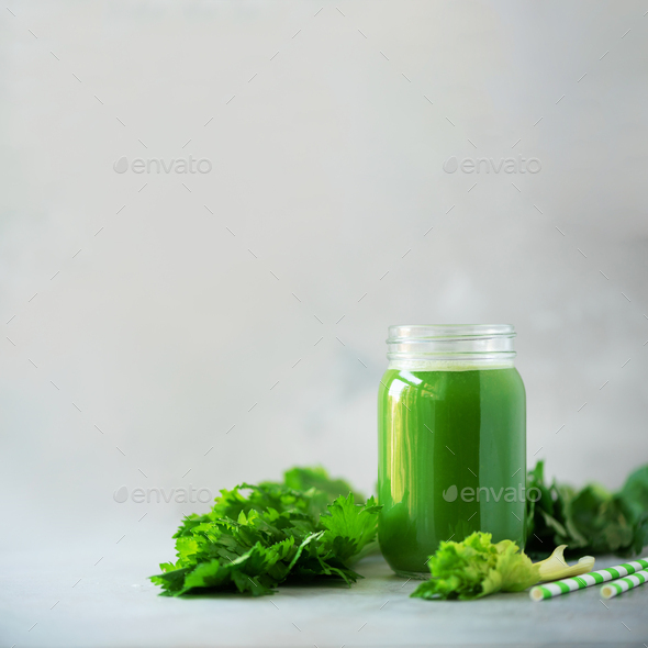 Bottle of green celery smoothie on grey concrete background with copy space. Square crop. Fresh - Stock Photo - Images