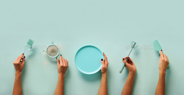 Female hands holding kitchen tools, sieve, rolling pin, plate, sieve, brush, whisk, spatula for - Stock Photo - Images