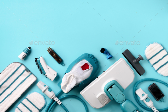 Kit of modern professional steam cleaners on blue background. Top view, flat lay. Banner with copy - Stock Photo - Images