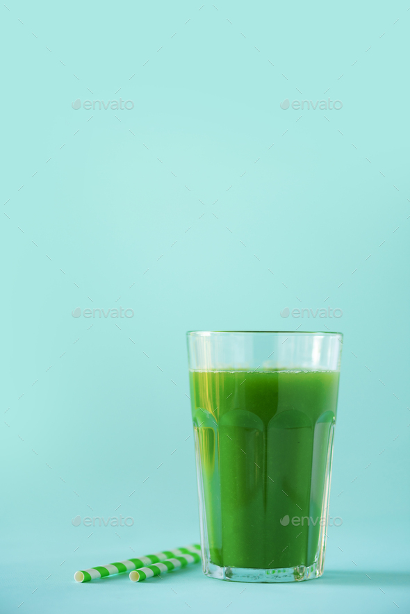 Glass of green celery smoothie on blue background. Banner with copy space. Fresh juice for detox - Stock Photo - Images