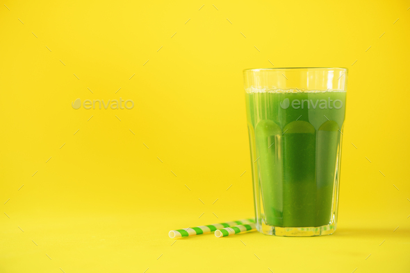 Glass of green celery smoothie on yellow background. Banner with copy space. Fresh juice for detox - Stock Photo - Images