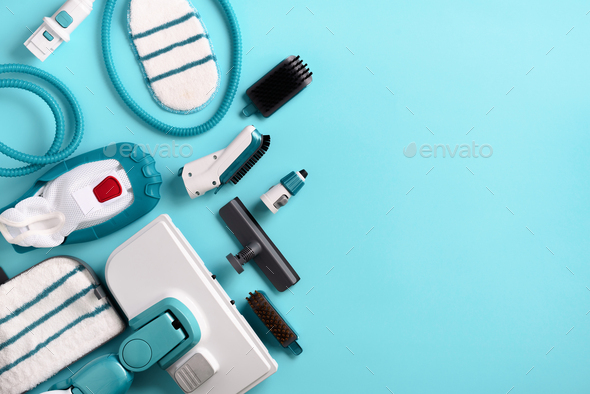Kit of modern professional steam cleaners on blue background. Top view, flat lay. Banner with copy - Stock Photo - Images
