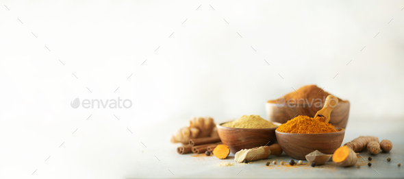 Ingredients for hot ayurvedic drink. Turmeric powder, curcuma root, cinnamon, ginger, lemon over - Stock Photo - Images